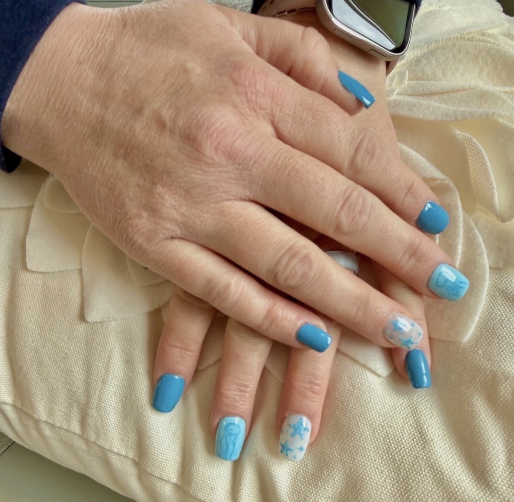 Hand-painted beach-inspired nails featuring jellyfish and starfish